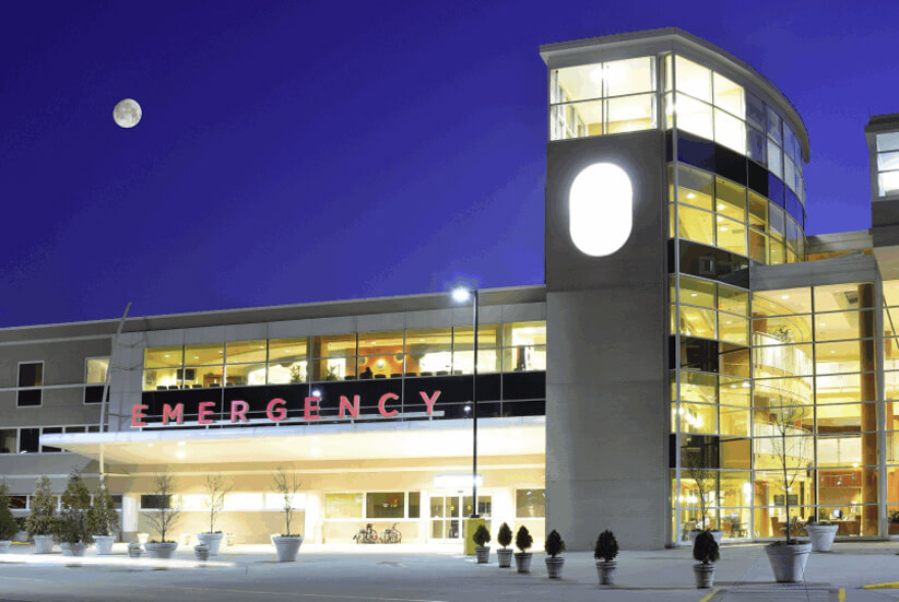 A large building with people standing outside of it.